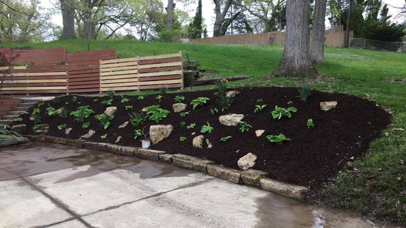 Fresh mulch installation in garden beds in Huntersville NC by Home Grooming